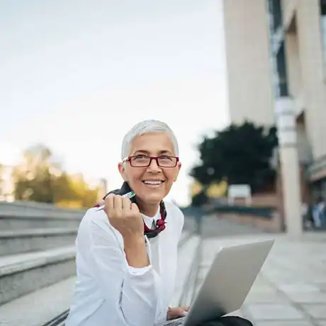 Woman sitting outside with laptop